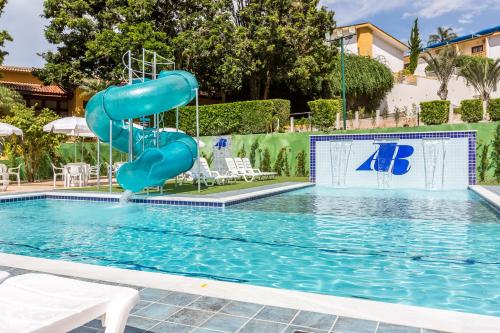 a swimming pool with a water slide in a resort at Atibaia Residence Hotel & Resort in Atibaia