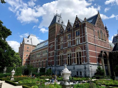 a large brick building with a fountain in front of it at Hotel JL No76 in Amsterdam