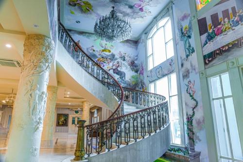 a staircase in a building with a painting on the wall at V20 Boutique Jacuzzi Hotel in Bangkok