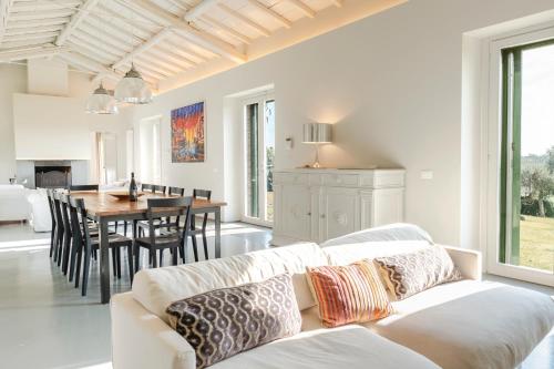 a living room with a couch and a dining room at Borgo Syrah in Cortona