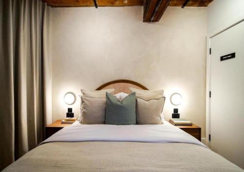 a bedroom with a large bed with two night stands at Organica by The Heim in Manchester