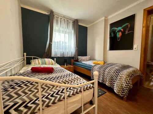 a bedroom with two beds and a window at Große Post in Schleiden