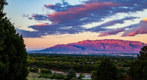 a view of a mountain at sunset at Holiday Inn Express & Suites Albuquerque Historic Old Town by IHG in Albuquerque