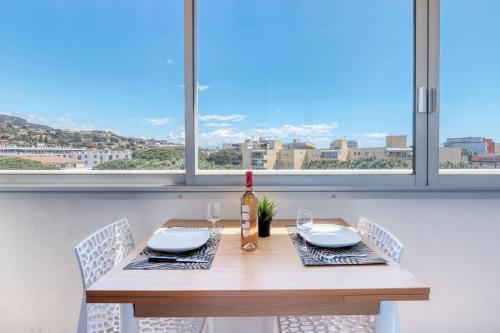 une table à manger avec deux chaises et une fenêtre dans l'établissement T2 600 m from the beach! Air-conditioned, au Lavandou