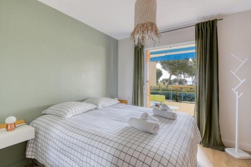 une chambre avec un lit avec deux serviettes dessus dans l'établissement Recent T3 in residence with swimming pool in La Favière, à Bormes-les-Mimosas