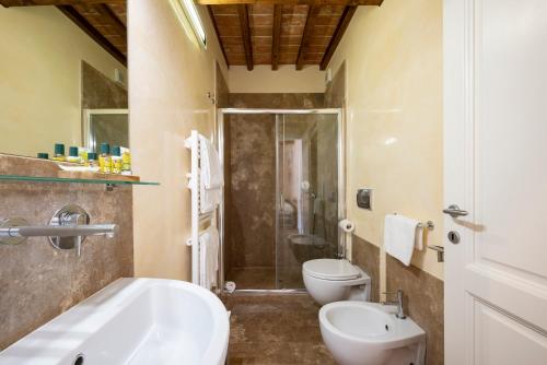 a bathroom with a sink and a toilet and a shower at Podere Vignanova Accommodations & SPA in Castagneto Carducci