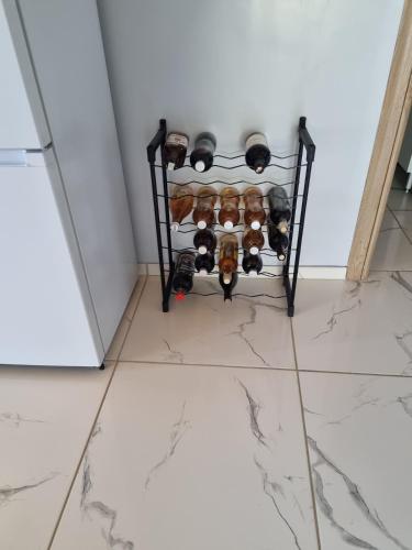 a bunch of wine bottles on a shelf in a room at Sunrise View Chalet in Trăisteni