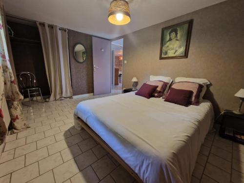 a bedroom with a large bed in a room at La forge des vignes in Menetou-Râtel