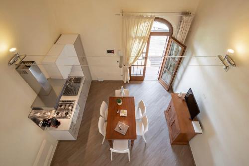 an overhead view of a kitchen and dining room with a table at Podere Vignanova Accommodations & SPA in Castagneto Carducci