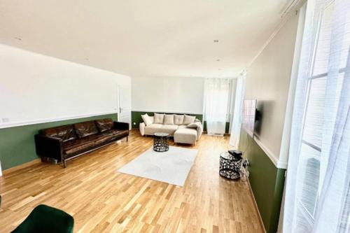 a living room with a couch and a table at Charming T3 on the seafront in Villers-sur-Mer