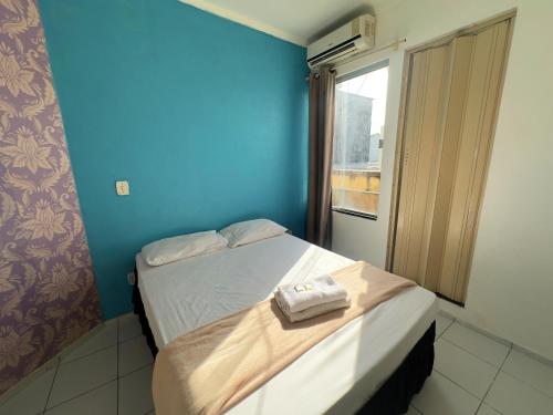 a small room with two beds and a window at Solar dos Poetas in São Luís