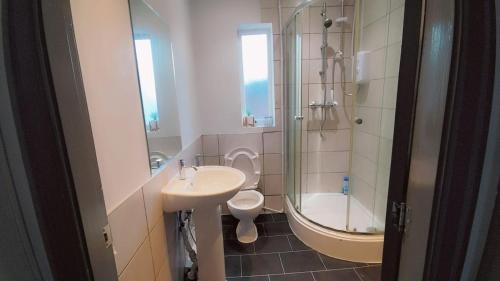 a bathroom with a sink and a toilet and a shower at Double-Bedroom in the Heart of Eccles Manchester BH2 Perfect for Short Stays in Manchester