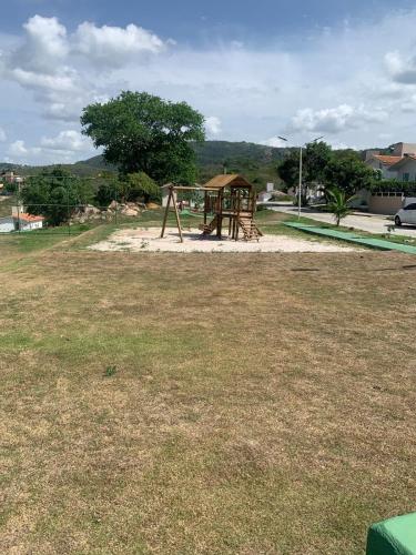 a playground with a swing set in a park at Casa de Campo com Jacuzzi em Gravatá in Gravatá