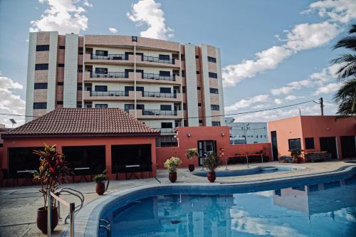 a hotel with a swimming pool in front of a building at hOTEL IMAN in Nouakchott