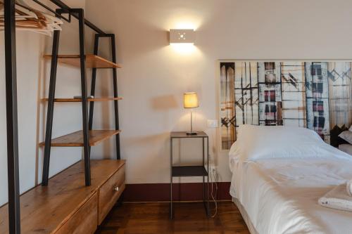 a bedroom with a bunk bed and a bed with a lamp at Borgo Syrah in Cortona