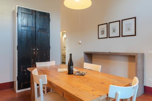 a dining room table with a bottle of wine on it at Borgo Syrah in Cortona