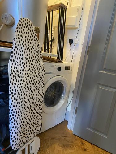 a white washing machine in a room with a door at Roman Bath View, Bath Keys in Bath