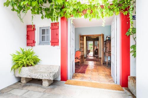 an open door to a house with red accents at La Devinière in Saint-Jean-de-Luz