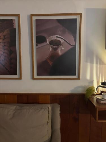 a living room with two pictures on the wall at Hotel Finca Lerida Coffee Plantation and Boutique Hotel in Boquete