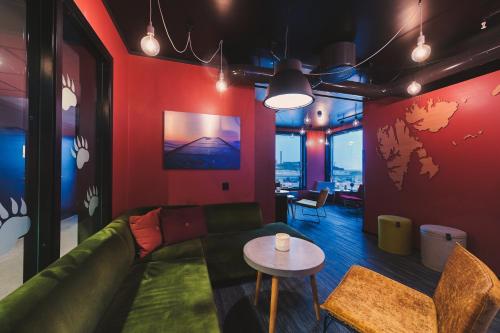 a living room with a couch and a table at Svalbard Hotell | The Vault in Longyearbyen