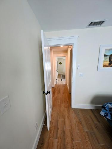 a hallway with white walls and a wooden floor at The Fish Shack in Saint James City