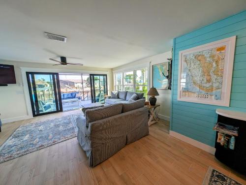 a living room with a couch and a map on the wall at The Fish Shack in Saint James City