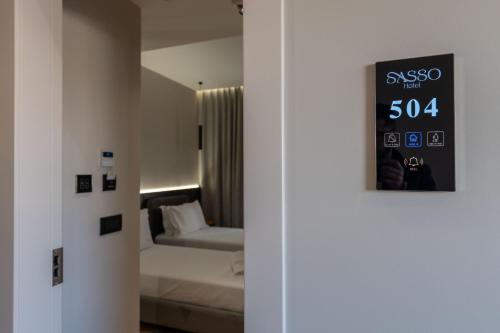 Postel nebo postele na pokoji v ubytování Sasso Hotel