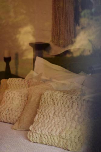a bed with a blanket and pillows on it at San Julio Campestre in Borrero Ayerbe