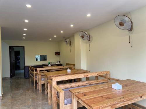 a dining room with wooden tables and chairs at Hotel Karma Inn in Pokhara