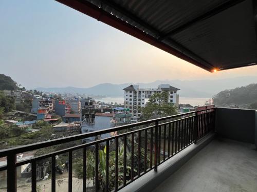 a balcony with a view of a city at Hotel Karma Inn in Pokhara