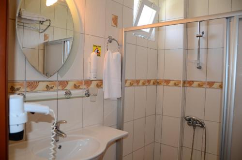 ein Badezimmer mit Waschbecken und Dusche mit Spiegel in der Unterkunft Hotel Keskin in Dalyan