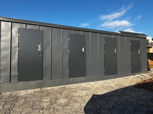 a large metal building with four doors on it at STEZKA horský apartmán Dolní Morava in Dolní Morava