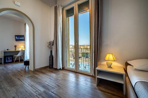 a bedroom with a bed and a large window at Florence Ventuno B&B in Florence