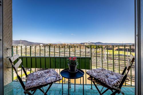 a balcony with two chairs and a table with flowers at Florence Ventuno B&B in Florence