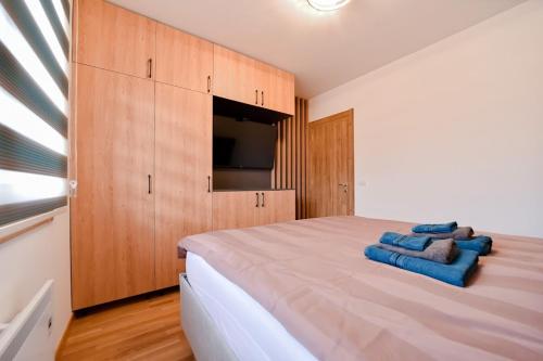 a bedroom with a large bed and wooden cabinets at Gorski Elegance 1 in Zlatibor