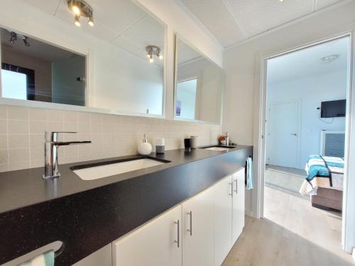 a kitchen with a sink and a mirror at Casa Spruit in Rojales