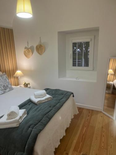 a bedroom with a bed with two towels on it at Home at Évora's Main Street in Évora