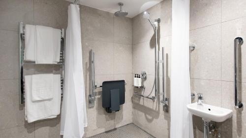 a bathroom with a sink and a shower at Crowne Plaza Birmingham City by IHG in Birmingham
