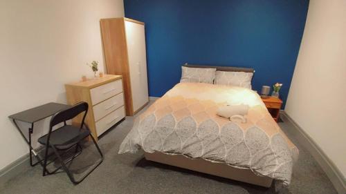a bedroom with a bed and a desk and a chair at Double-Bedroom in the Heart of Eccles Manchester BH4 Perfect for Short Stays in Manchester