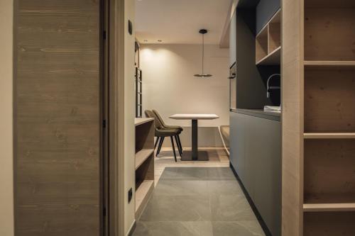 a small kitchen with a table and a dining room at Haunold Homes in San Candido