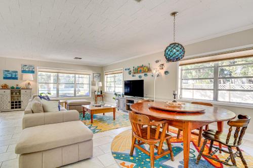 a living room with a table and a couch at Dock and Lanai Riverview Homosassa Escape! in Homosassa