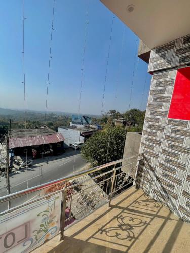 a balcony with a view of a street at Lotus Homestay in Bharwain