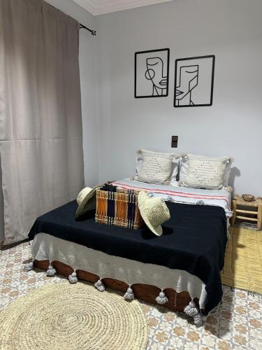 a bedroom with a bed with a black blanket at Villa Sakina home with private pool sidi kaouki in Essaouira