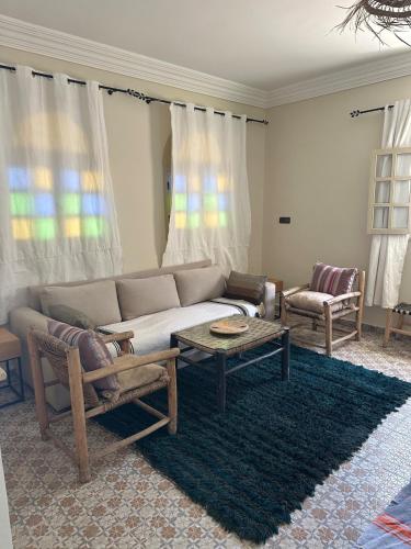 a living room with a couch and a table at Villa Sakina home with private pool sidi kaouki in Essaouira