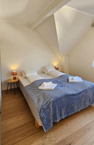 a bedroom with a large bed with two towels on it at Best view in town in Bergen