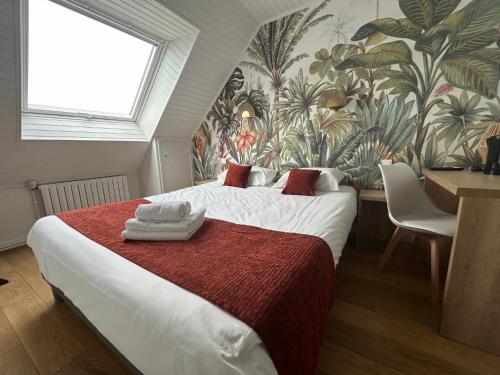 a bedroom with a large bed with a floral wallpaper at Brit Hotel des Halles in Concarneau