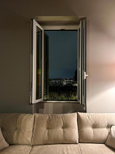 a couch in front of a window with a view at Acropolis 360 Residence,2 bedr in Athens