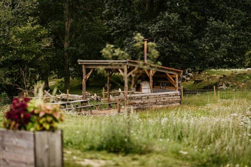 a wooden gazebo in the middle of a field at Ödevata Gårdshotell in Emmaboda
