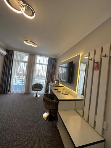 a hotel room with a desk and a television at Hotel Forras in Komárom