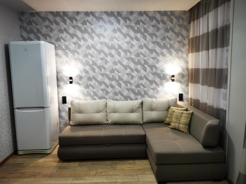 a living room with a couch and a refrigerator at Green Apartments in Chernihiv